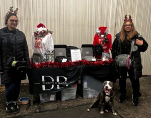 Dobbybags stall at Christmas with Reena and her cousin and dog